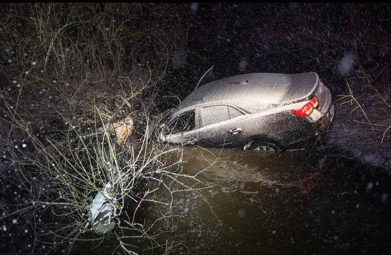 Two people were able to get themselves out of a vehicle after it slid off the roadway and came to rest in a creek near Harvard March 15. 2026.