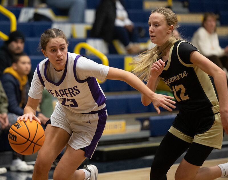 Plano’s Josie Larson drives against Sycamore’s Sadie Lang Monday, Feb. 17, 2025, during a 3A semifinal in Sterling.