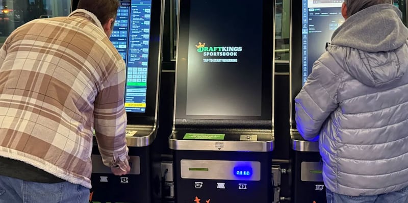 Bettors gather at the DraftKings betting kiosks at Chicago’s Wrigley Field. Despite having one of the most aggressive tax structures, Illinois still ranks third in the U.S. in sports betting revenue.