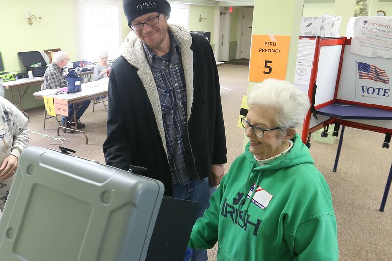 Nathan Endicott casts his ballot with election judge Shelia Abraham on Tuesday, March 17, 2026 at Zion United Church of Christ in Peru.