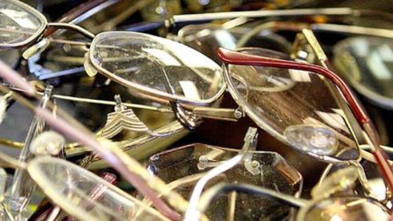 Piles of eyeglasses sit on a conference table Wednesday at the Lions of Illinois Foundation in Sycamore. Donated eyeglasses are sorted, and those with plastic frames are sent to Lions Club International in Indiana to be graded, cleaned and shipped to needy countries. KATE WEBER CARLSON | kcarlson@daily-chronicle.com