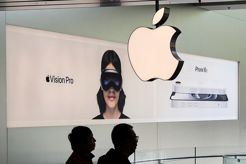 FILE - People visit an Apple Store, inside a shopping mall, in Beijing, Thursday, April 10, 2025. (AP Photo/Andy Wong, File)