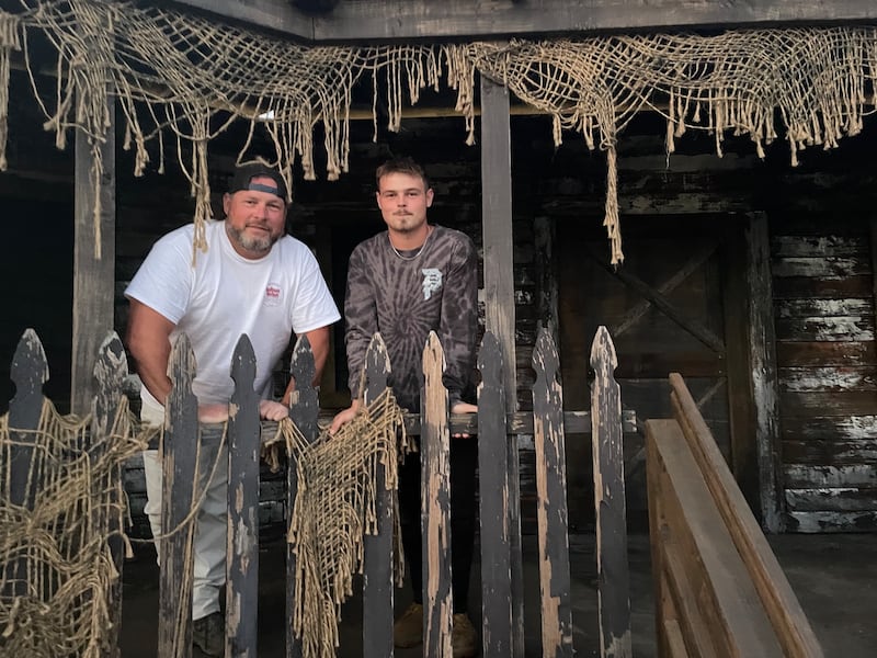 Father-son duo Jason and Tristan Wright stand in one of the sets they've been building in a Spring Grove cornfield, where the Wrights will open the American Nightmare Scream Park Thursday, Oct. 2.