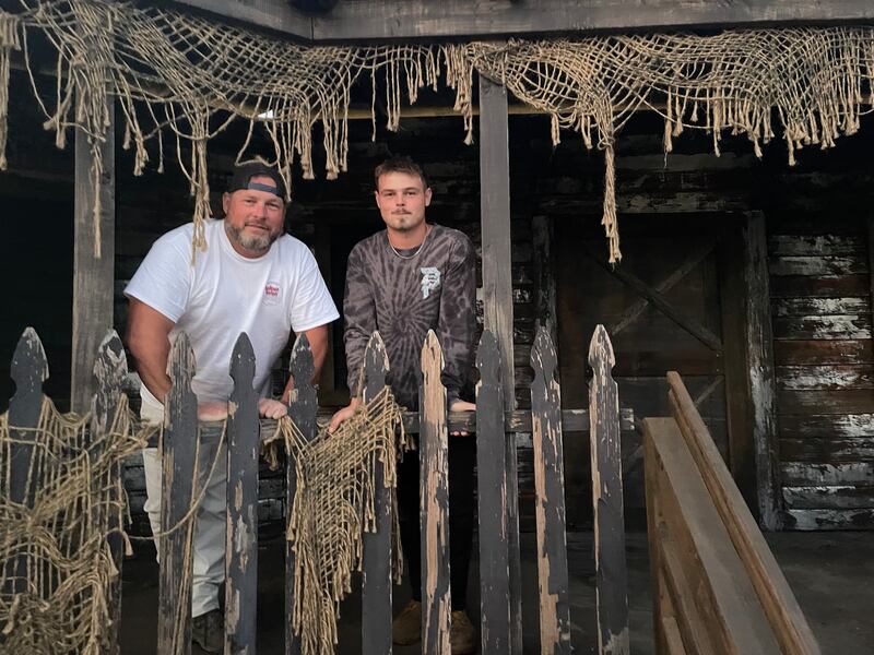 Father-son duo Jason and Tristan Wright stand in one of the sets they've been building in a Spring Grove cornfield, where the Wrights will open the American Nightmare Scream Park Thursday, Oct. 2.