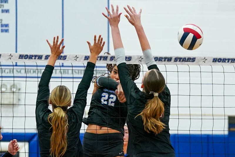 St. Charles North's Sidney Wright (22) watches her kill attempt sail past Huntley’s Lucy Watson (right) during a  non-conference match at St. Charles North High School on Wednesday, Sept. 3, 2025.