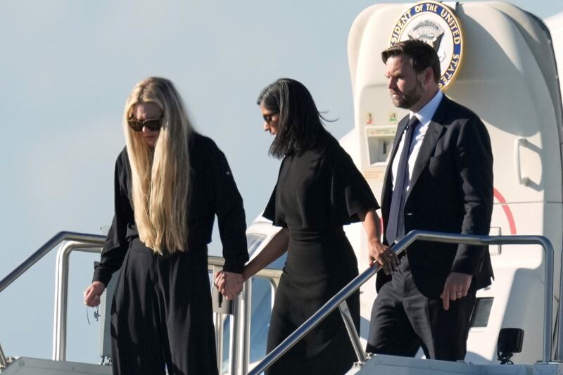 Vice President JD Vance, right, Second Lady Usha Vance, center, and Erika Kirk, holding a cross on a chain, deplane Air Force Two, carrying the body of Charlie Kirk, the CEO and co-founder of Turning Point USA who was shot and killed, Thursday, Sept. 11, 2025, in Phoenix. (AP Photo/Ross D. Franklin)