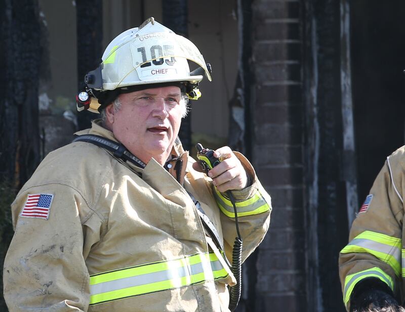 Oglesby Fire Chief Ron Popurella radios to dispatch during a fire at a duplex home in the 200 block of Sunset Boulevard on Tuesday, Oct. 24, 2023 in Oglesby.