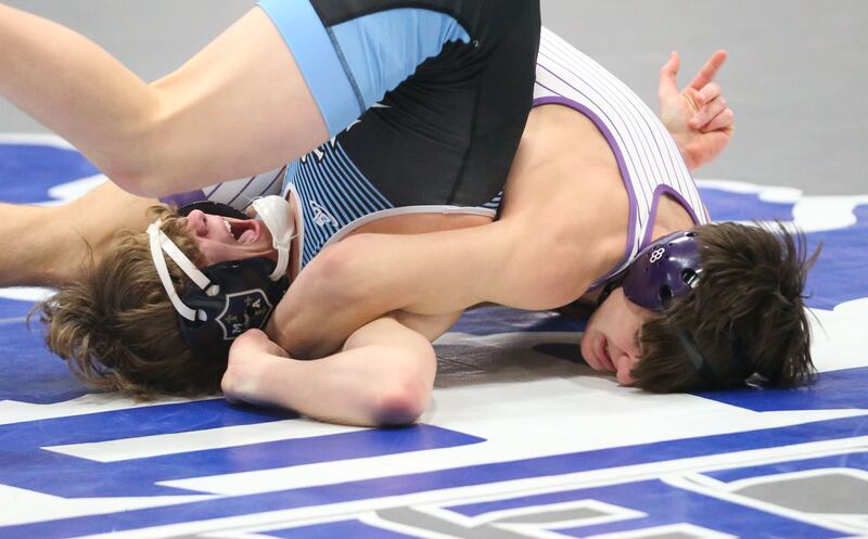 Marquette's Logan Huenefeld wrestles Dixon's Doolan Long during the Class 1A Regional meet on Saturday, Jan. 31, 2026 at Princeton High School.