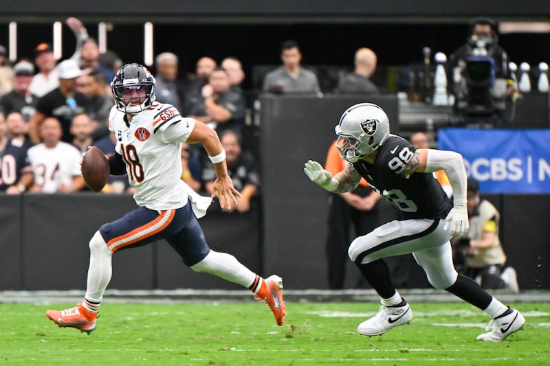 Chicago Bears quarterback Caleb Williams (18) is chased by Las Vegas Raiders defensive end Maxx Crosby (98) during the first half of an NFL football game Sunday, Sept. 28, 2025, in Las Vegas. (AP Photo/David Becker)