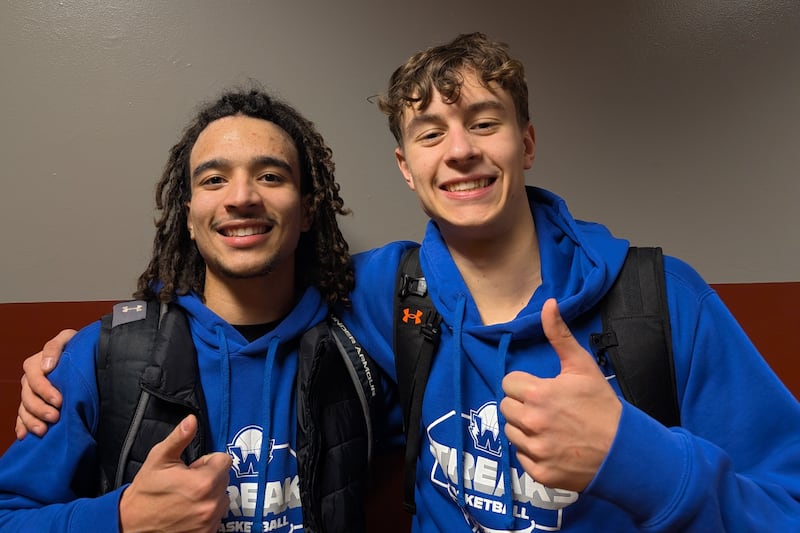 Woodstock's JJ Stokes (left) and Max Beard pose for a picture after leading the Blue Streaks to a 58-57 win over Marengo in Kishwaukee River Conference boys basketball action Friday, Jan. 30, 2026, in Marengo.