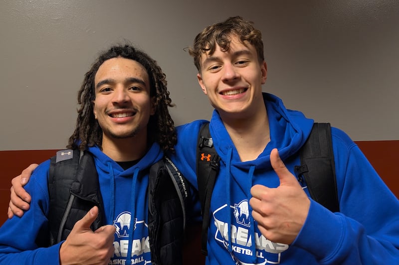 Woodstock's JJ Stokes (left) and Max Beard pose for a picture after leading the Blue Streaks to a 58-57 win over Marengo in Kishwaukee River Conference boys basketball action Friday, Jan. 30, 2026, in Marengo.
