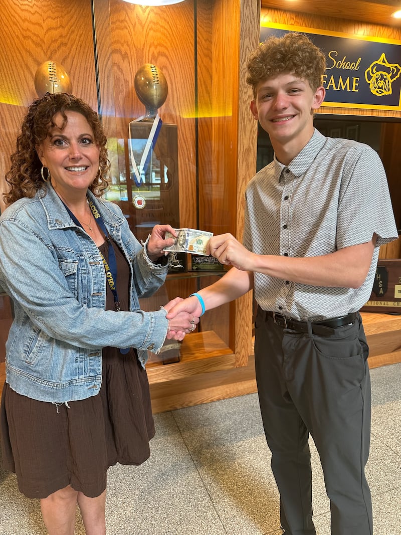 Byron Grobe (right) was recently chosen as the March Student of the Month at Polo Community High School. He was presented with a scholarship by Alissa Zeigler (left) of the Polo Schools Foundation.