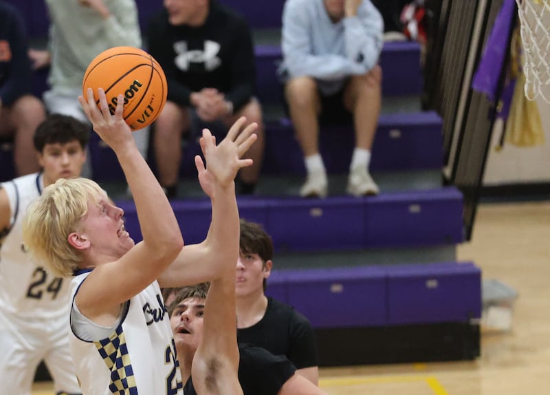 Earlville's Jonathan Anderson looks to pass the ball over the top of Marquette's Slayden Cassel during the Huskers Hardwood Tip-Off Tournament on Tuesday, Nov. 25, 2025 in Serena.