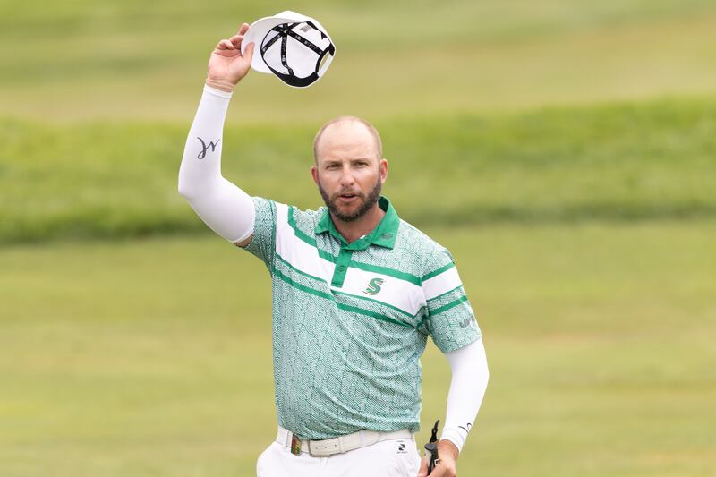 First-place individual champion Dean Burmester of Stinger GC gestures to the crowd on the 18th green following the final round of LIV Golf Chicago at Bolingbrook Golf Club on Sunday, August 10, 2025, in Bolingbrook.