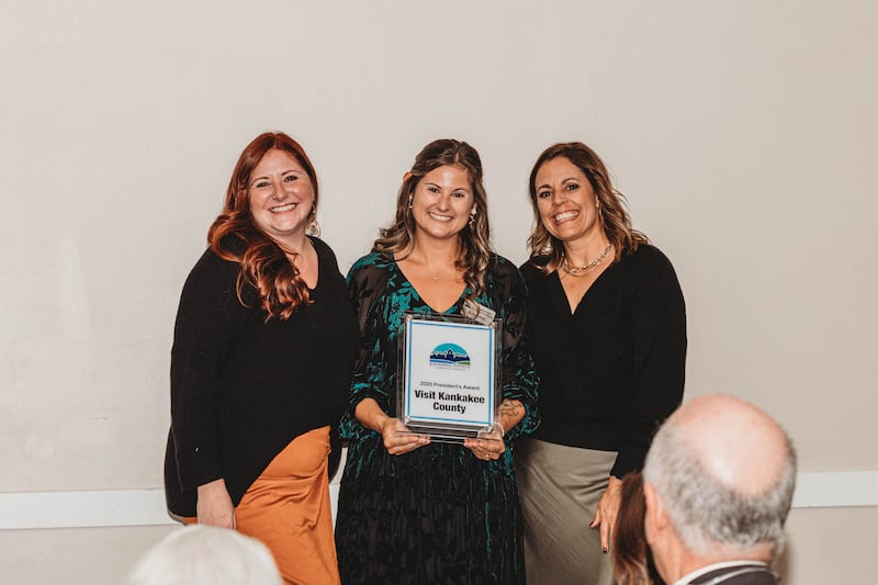 Visit Kankakee County Executive Director Nicole Gavin, right, and Angelina Gear, Sales & Marketing Manager, left, accept the the President’s Award from Kankakee County Chamber of Commerce president and CEO Kelsey Post during the chamber's annual Gala & Awards on Thursday, Nov. 6, 2025.