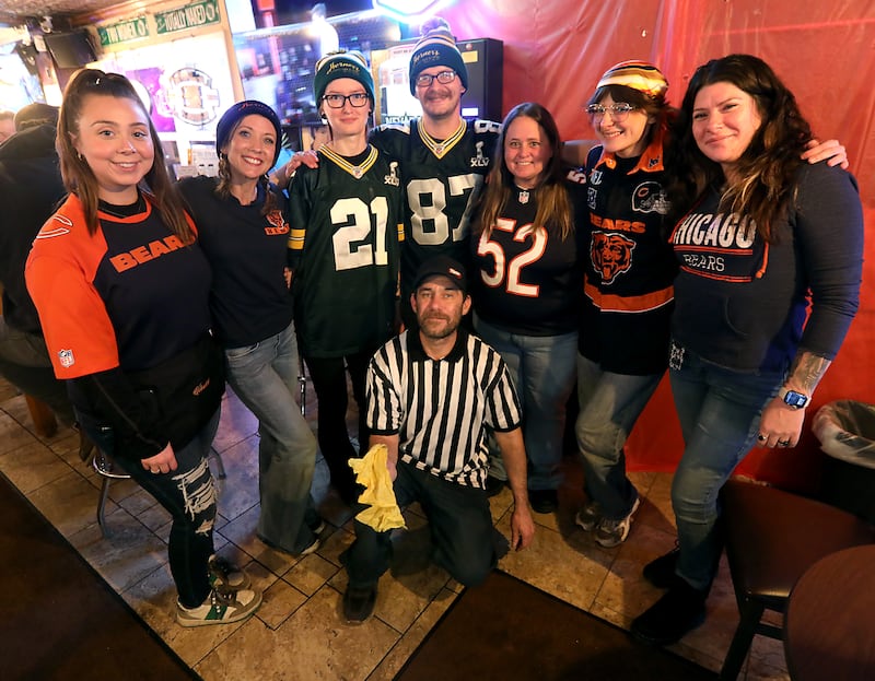The staff at Herner's Hideaway sports Bears and Packers clothing at the bar in Genoa City, Wis., on Friday, Jan 9, 2026. The bar is officially a Green Bay Packer's bar but splits about 50-50 between Packers' fans and Chicago Bears' fans.