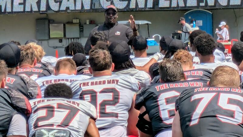 NIU coach Thomas Hammock talks to his team after practice Saturday, Aug. 9, 2025, at Huskie Stadium in DeKalb.