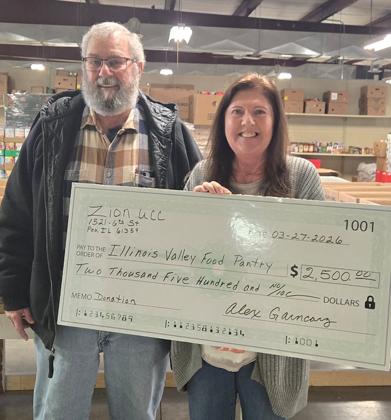 Larry Grosenbach (left), council president for Zion United Church of Christ in Peru, presents a $2,500 check to Mary Jo Credi, executive director of the Illinois Valley Food Pantry Director. The donation was funded by church fundraisers and personal donations from the congregation. Zion UCC has been a strong supporter of IV Food Pantry since the pantry was founded.