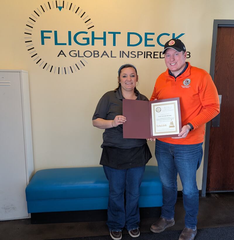 State Rep. Brad Fritts (right) presents Flight Deck owner Ashley Bick with his local business highlight award for April 24 at the Rochelle business.