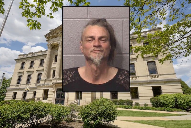 Ronny W. Reynolds was charged on Friday, Nov. 21, 2025, with threatening a public official after police said he entered DeKalb City Hall on Thursday and made verbal threats to a city official, then later threatened multiple people, including police, with a broken scissor blade, according to court records. (Inset photo provided by DeKalb County Jail)