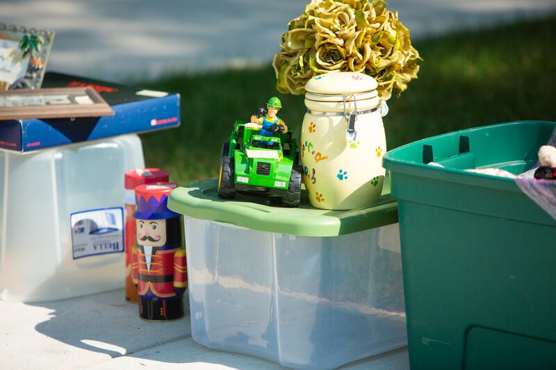 Toys and household items line the driveway of one of a  Westmont home during the town’s weekend garage sales, Saturday, August 3, 2024.