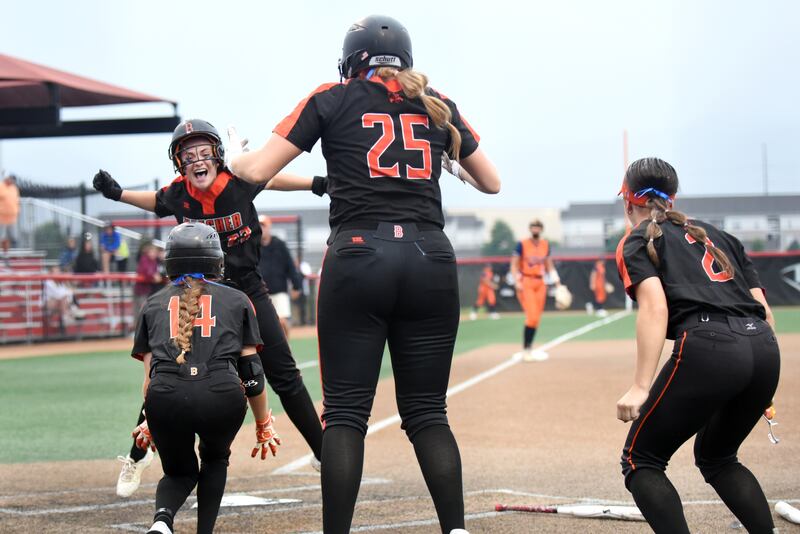 Beecher's Tayiah Scanlan, top left, is congratulated by Liliana Irwin after crossing the plate after her go-ahead inside-the-park home run in the 10th inning of the IHSA Class 2A State championship game against Carterville at the Louisville Slugger Complex in Peoria Saturday, June 7, 2025. Abrianne Papas (25) and Makenzie Johnson are also in the celebration.