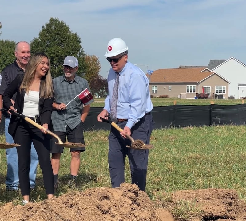 Jennifer Herrera with St. Jude Children's Research Hospital and Sycamore Mayor Steve Braser throw dirt during the groundbreaking of a new Chicagoland St. Jude Dream Home Showplace in Sycamore on Oct. 1, 2025, while 3rd Ward Alderman Marvin Barnes and others watch.