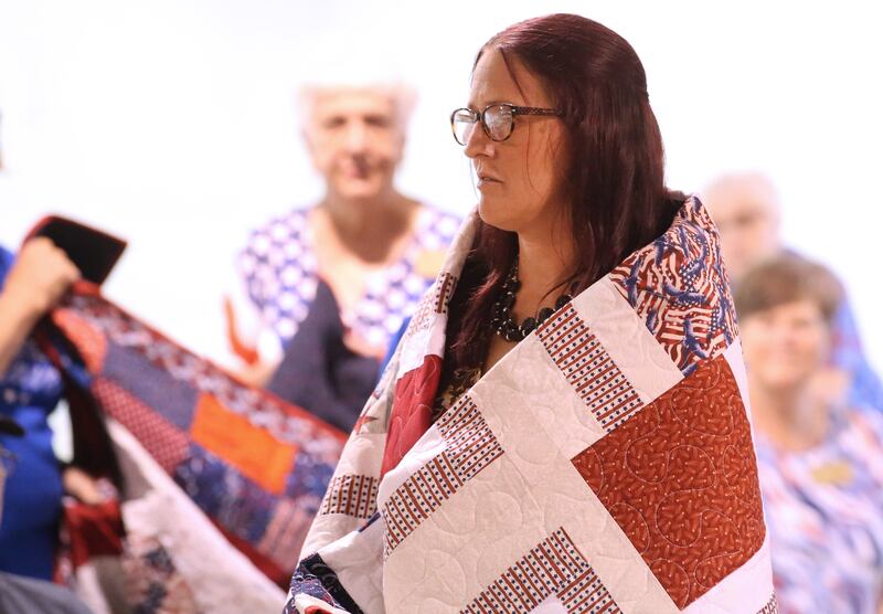 U.S. Army Veteran Amanda Gibson, of Princeton, receives her Quilt of Valor during the Tribute to Veterans on Wednesday, Aug. 20, 2025 at the Bureau County Fair in Princeton.