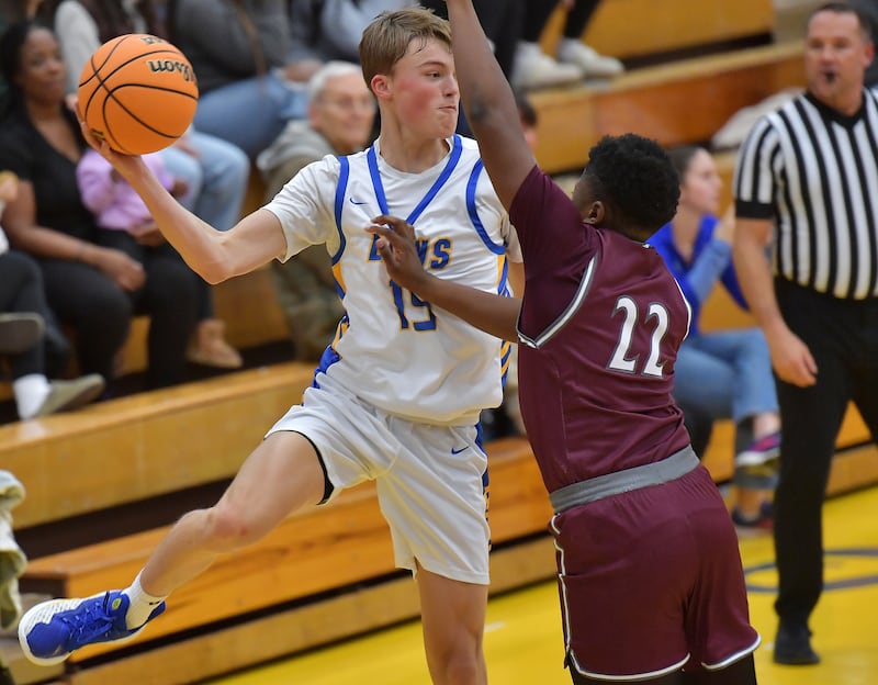 Lyons Township's Timmy Sloan first a pass as Morton's Jamari Watkins (22) defends during a Thanksgiving Tournament game on November 25, 2024 at Lyons Township High School in LaGrange.