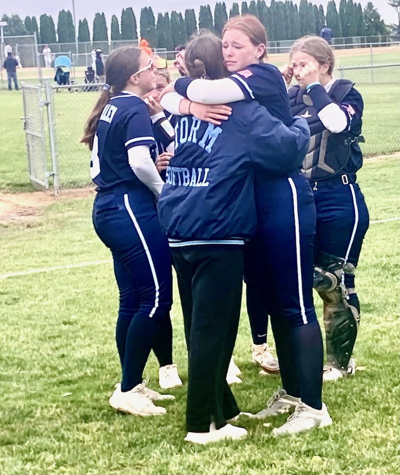 Bureau Valley's Mallery Maubach receives a hug from senior teammate Lesleigh Maynard following Wednesday's 10-0 loss to Stillman Valley in the regional semifinal game at Manlius.