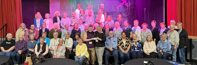 Dede Forrest of 100+ Women Who Care of Ogle County presents a check to Kristin Dubois of the Polo Area Community Theater.