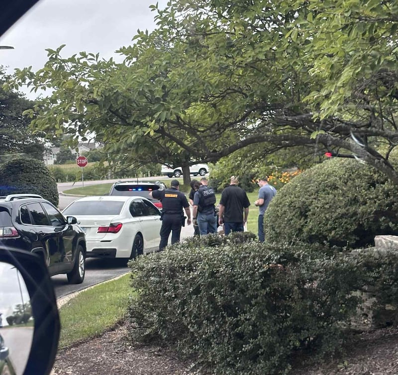 A Kane County Sheriff's deputy (left) translates a warrant issued for Orlando Manriquez-Valdivia from Homeland Security Investigations on Thursday, July 17, 2025, at the Judicial Center in St. Charles. The HSI officer has POLICE on the back of his vest. Manriquez-Valdivia is in ICE custody in Broadview as of Friday, July 18, according to officials and public records.