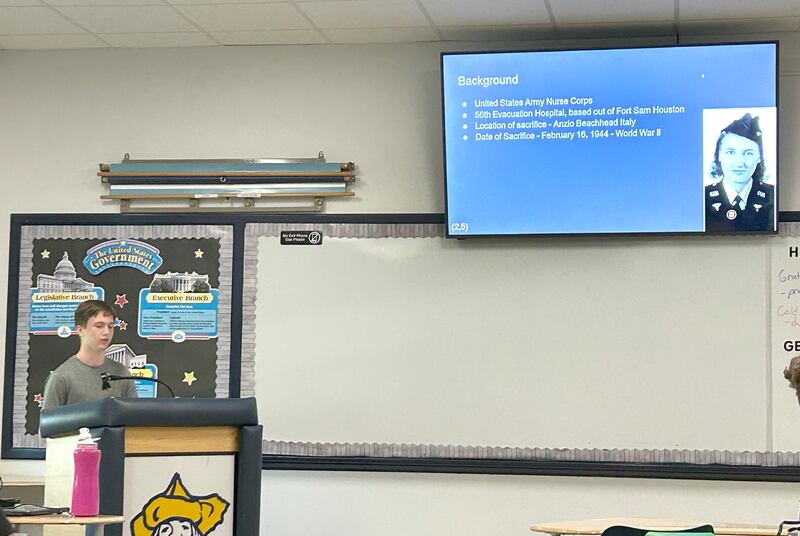 Polo High School Junior Joe Rowland (left) gives his presentation to his class on Thursday, May 15, 2025 about Ellen Ainsworth, an Army nurse who died after refusing to leave her patients in Italy in 1944.