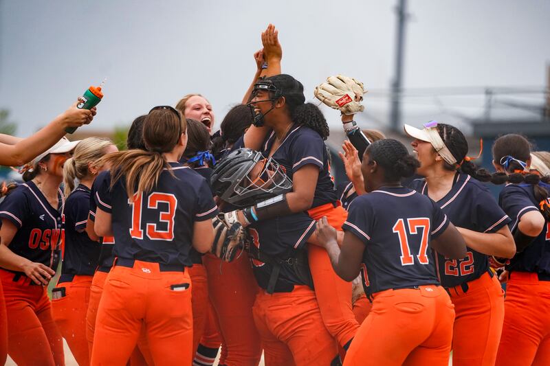 Oswego’s Kiyah Chavez (10) lifts Jaelynn Anthony (20) into the air as Oswego celebrates their victory over Neuqua Valley to win the Class 4A Oswego East Regional Softball Final at Oswego East High School on Friday, May 30, 2025.
