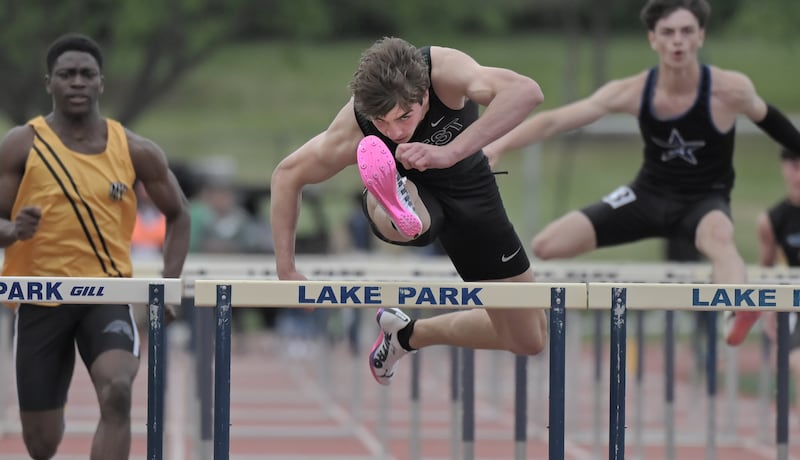 Glenbard West’s Ben Schoettle keeps his head down over the hurdles in the fast heat of the 100-meter hurdles at the IHSA Class 3A boys Track & Field Sectional Championships at Lake Park High School in Roselle on Friday, May 22, 2026.