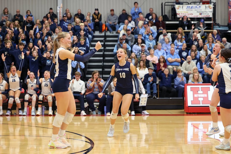 Cissna Park's Kendyl Neukomm celebrates a play by her sister, Josie Neukomm, left, during the Timberwolves' victory in two sets, 25-22, 25-11, over Windsor/Stewardson-Strasburg in the IHSA Class 1A Heyworth Super-Sectional on Monday, Nov. 10, 2025.