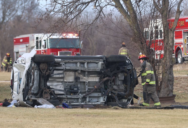 A La Salle firefighter inspects at a vehicle rollover near the entrance to La Sale Speedway on Monday, Jan. 12, 2026 on U.S. Route 6 in La Salle. The crash happened around 8:30a.m. Crews from Utica and La Salle responded to the scene. OSF Lifeflight helicopter landed in the parking lot of La Salle Speedway to transport one patent.