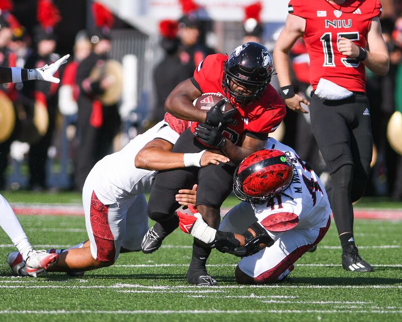 Northern Illinois University's quarterback Josh Holst (15) runs the before being tripped up by Sand Diego State university during the game on Saturday Sept. 27, 2025, held at Huskie Stadium in DeKalb.
