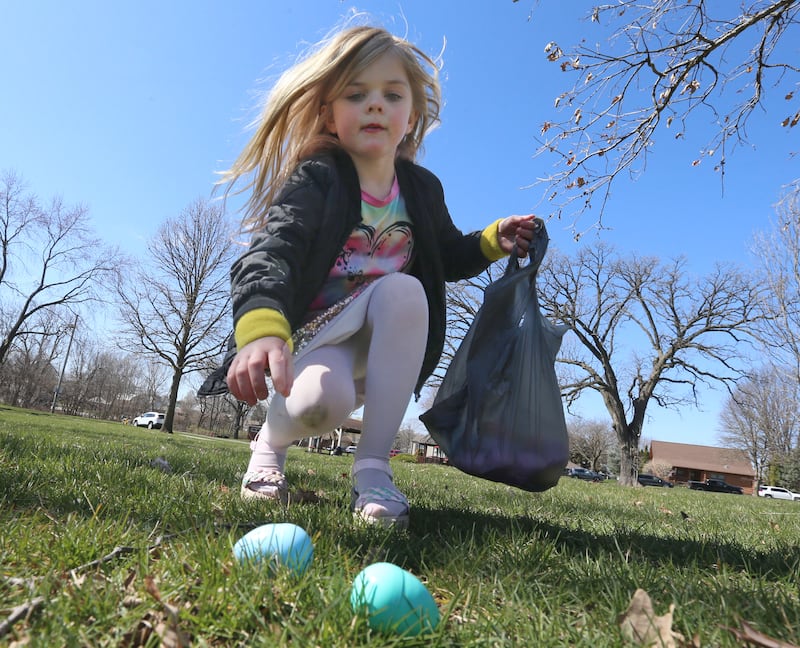 Baylor Benoit collects Easter eggs during the Easter egg hunt on Saturday, March 23, 2024 at Centennial Park in Peru.