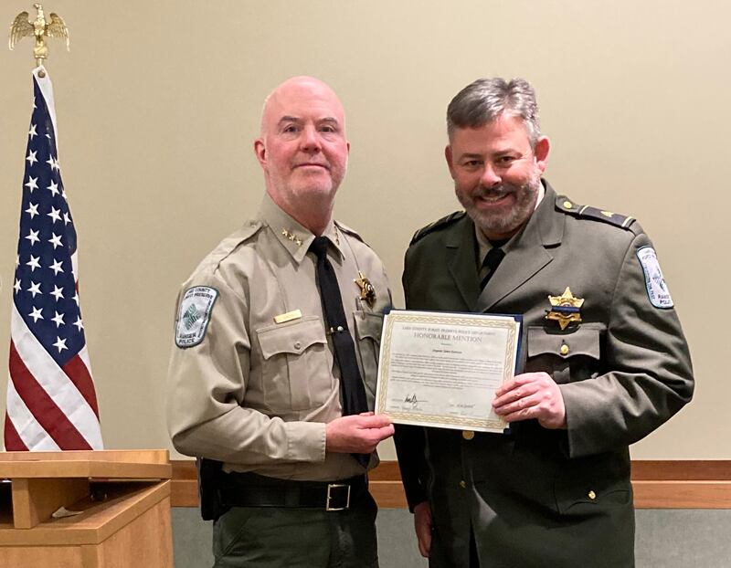 Chief Ron Davis gives Sgt. James Harrison a life-saving award for his bravery and clear thinking in a crisis.
