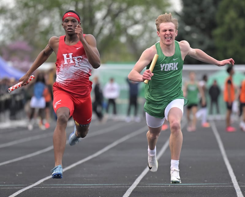 York’s Justin Cello beats Homewood Flossmoor’s Zion Morrison to the finish in the 4x100-meter relay at the Red Grange boys track invitational at Wheaton Warrenville South High School in Wheaton on Friday, April 15, 2025.