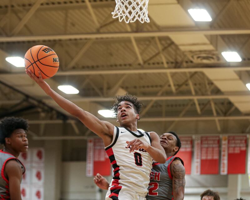 Benet's Blake Fagbemi (0) puts up a shot during their When Sides Collide Shootout basketball tournament matchup between Rich Township at Benet Academy. Jan 25, 2025 in Lisle.