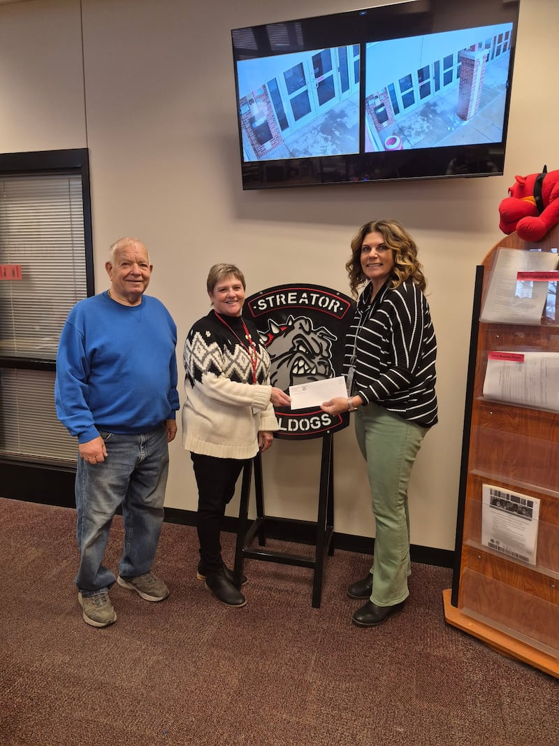 Amy Jo Lotshaw, principal of Streator Township High School, accepts a $1,000 donation from the Streator Elks Lodge #591 to support the school’s food pantry.