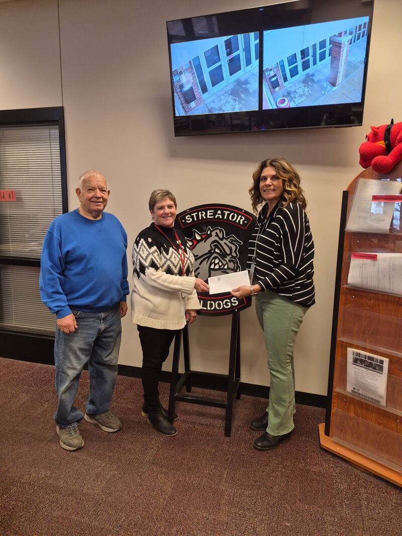Amy Jo Lotshaw, principal of Streator Township High School, accepts a $1,000 donation from the Streator Elks Lodge #591 to support the school’s food pantry.