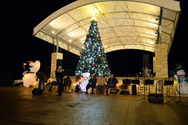 Chris King, of United County Sauk Valley Realty, reads the names of lost loved ones during the Love Light Tree ceremony that's part of Rock Falls' annual Hometown Holidays celebration on Friday, Nov. 17, 2023, in RW&B Park.
