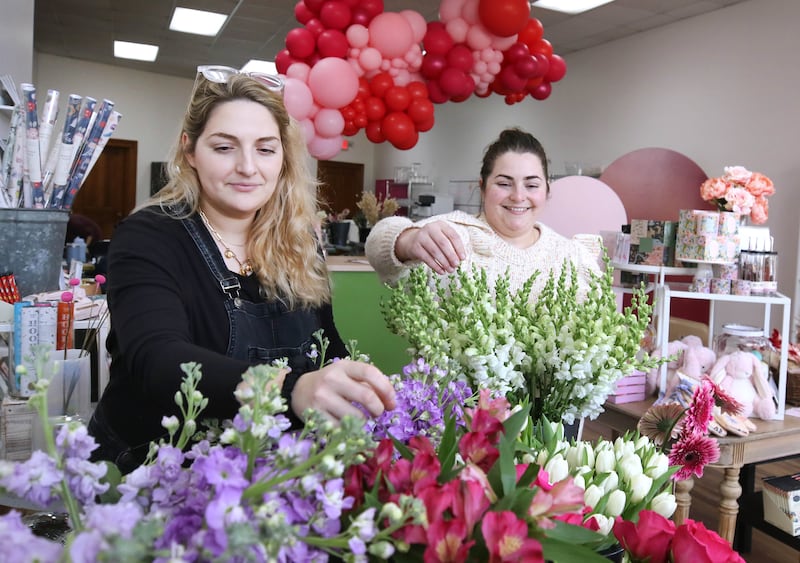 Kat Willrett (left) and Mary Grace McCauley, co-owners of Willrett Flower Company, get the shop set up Wednesday, Feb. 8, 2023, for Saturday’s Downtown DeKalb Sweet Stroll event. The event, which will take place from 1 to 4 p.m. Saturday, will see more than a dozen businesses play host to vendors of speciality sweets, as well as fun activities.