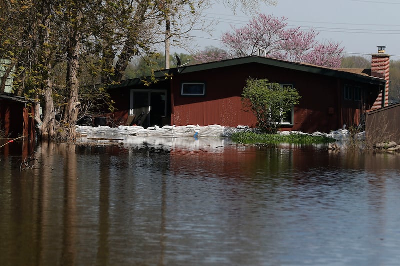 Sandbags protect a home in Holiday Hills  as flooding continues on the Fox River on Wednesday, April 22, 2026.