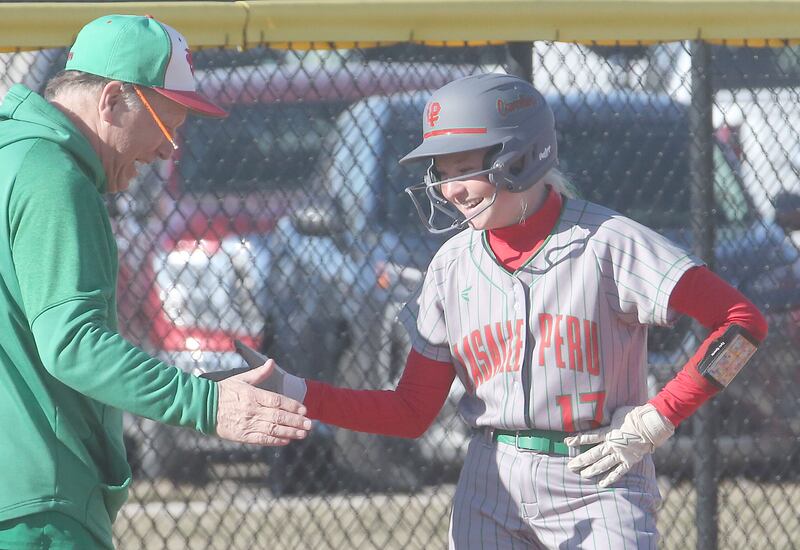 L-P's zzy Pecchio hi-fives head coach Randy Huebe after hitting a triple against Princeton on Tuesday, March 25, 2025 at the L-P Athletic Complex in La Salle.