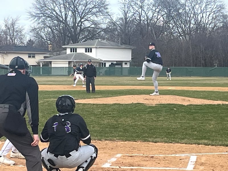Downers Grove North's Colin Doyle delivers a pitch during Tuesday's game with Oswego East in Downers Grove.