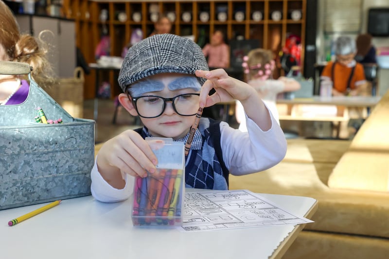 Shabbona Elementary School kindergartener Lucas Akai chooses a crayon while dressed up as a 100 year old for the 100th day of school on Monday, Feb. 9, 2026.